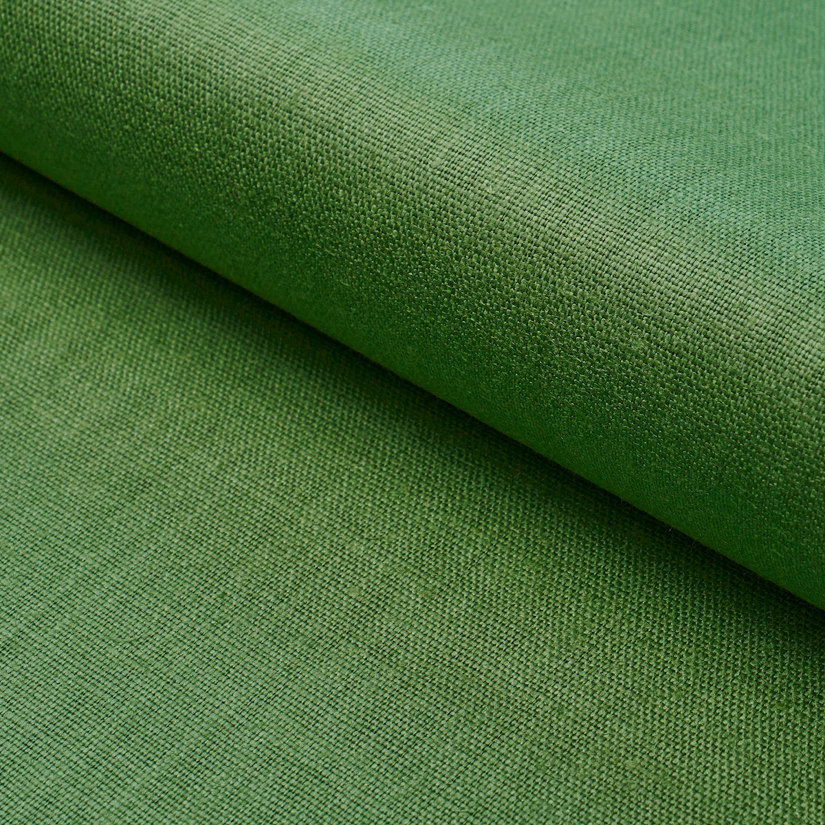 Green woven upholstery fabric roll with visible texture, ideal for furniture or crafts.