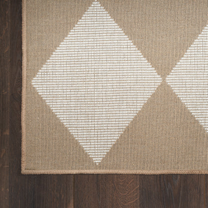 Beige-brown diamond-pattern rug with white diamonds, woven texture, bordered edge on dark wood floor.