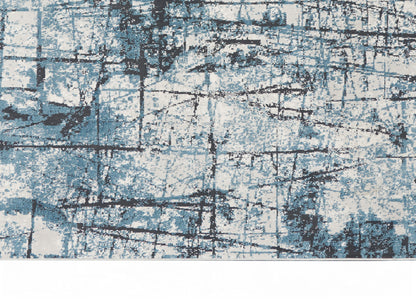 Abstract blue and white rug with distressed grid lines and charcoal accents for modern living spaces.