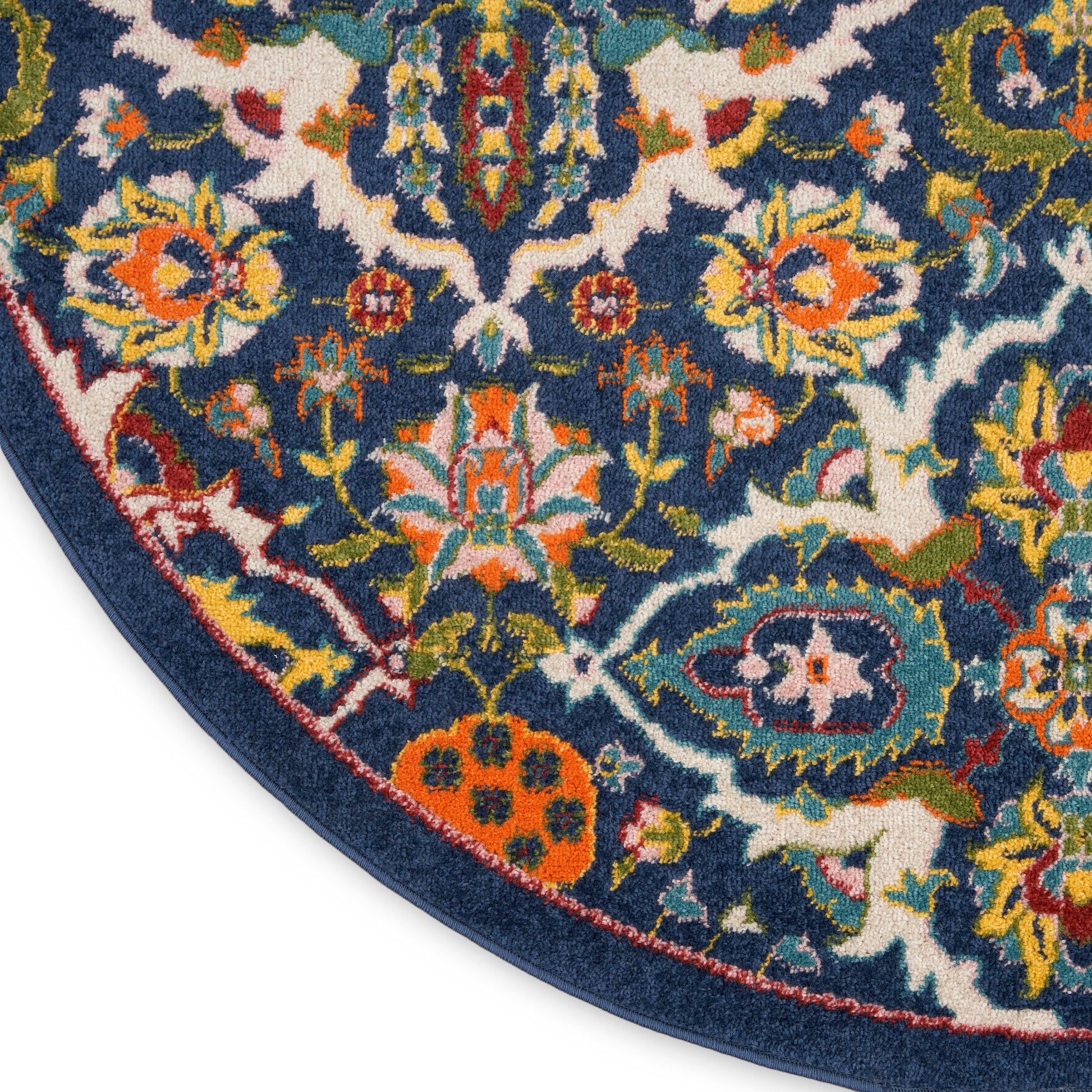 Round oriental rug with navy background and vibrant floral pattern in orange, pink, yellow, green; decorative border.