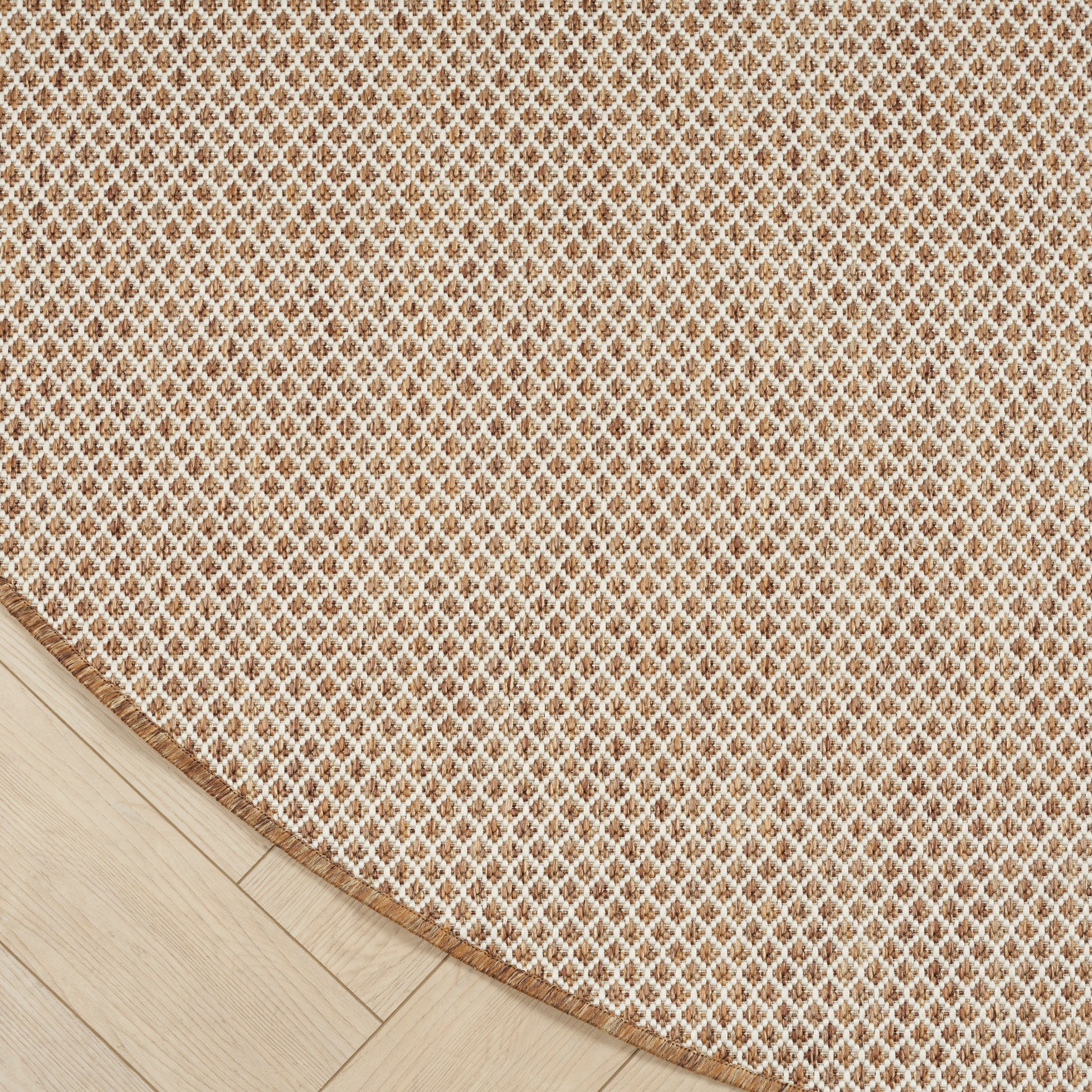 Beige gradient backdrop over light wood floor with a beige woven round rug partially visible; minimalist cozy decor.