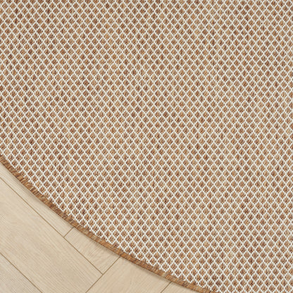 Beige gradient backdrop over light wood floor with a beige woven round rug partially visible; minimalist cozy decor.