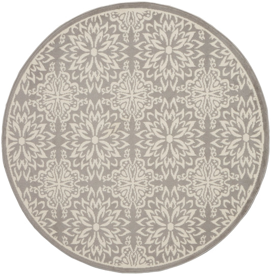 Round taupe rug with cream damask floral pattern; soft woven texture for living room decor.