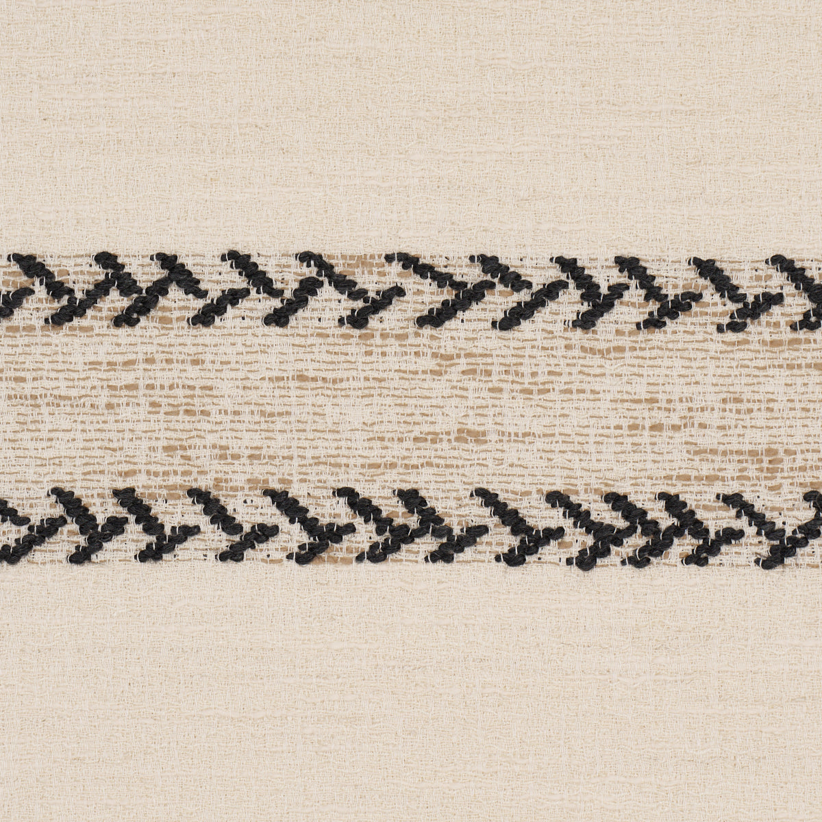 Beige woven fabric with two horizontal black zigzag chain-stitched embroidery stripes.