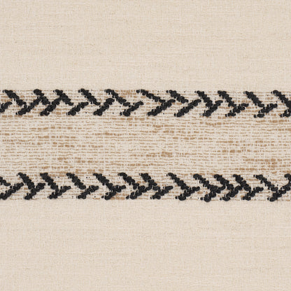 Beige woven fabric with two horizontal black zigzag chain-stitched embroidery stripes.
