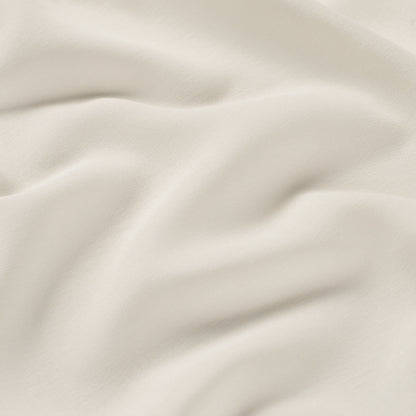 Cream-colored fabric with soft drapes and smooth, fine-textured weave.