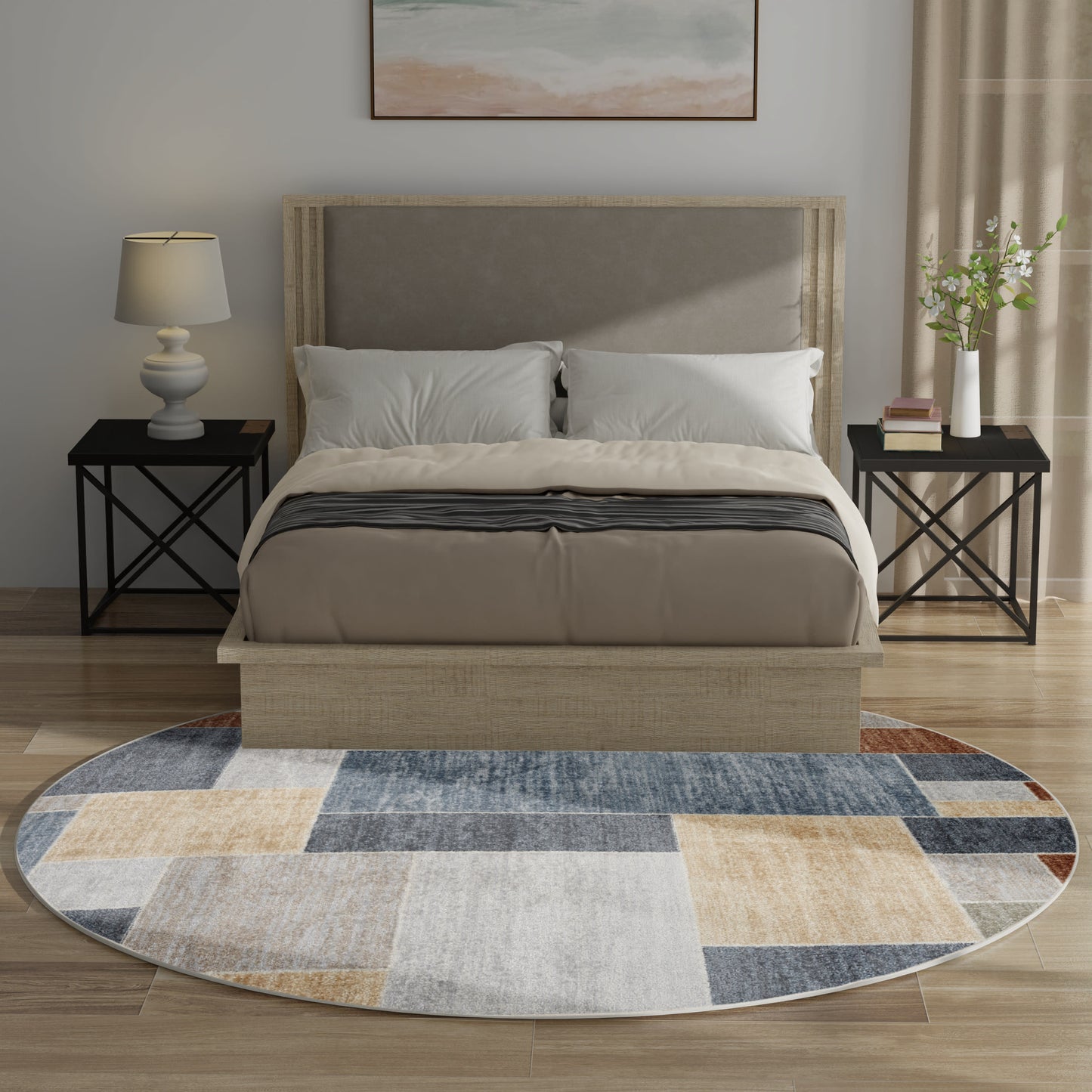 Beige upholstered platform bed with padded headboard, white bedding, black metal X-frame nightstands, and round patchwork rug.