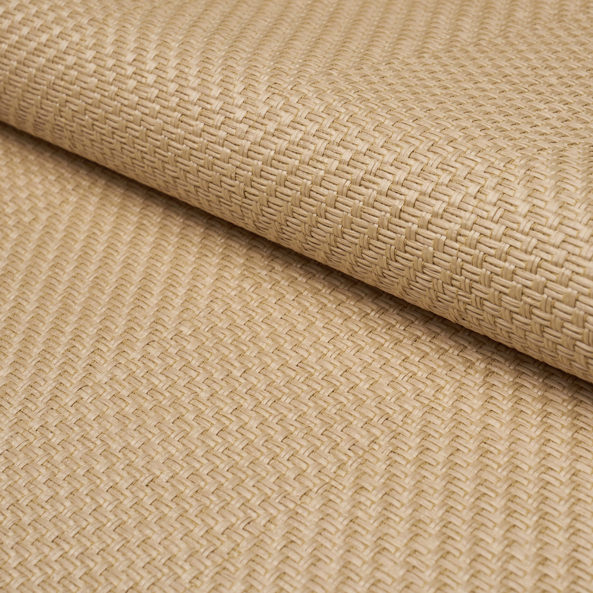 Beige woven seagrass mat roll with tight crosshatch texture, natural fiber for flooring or placemats.