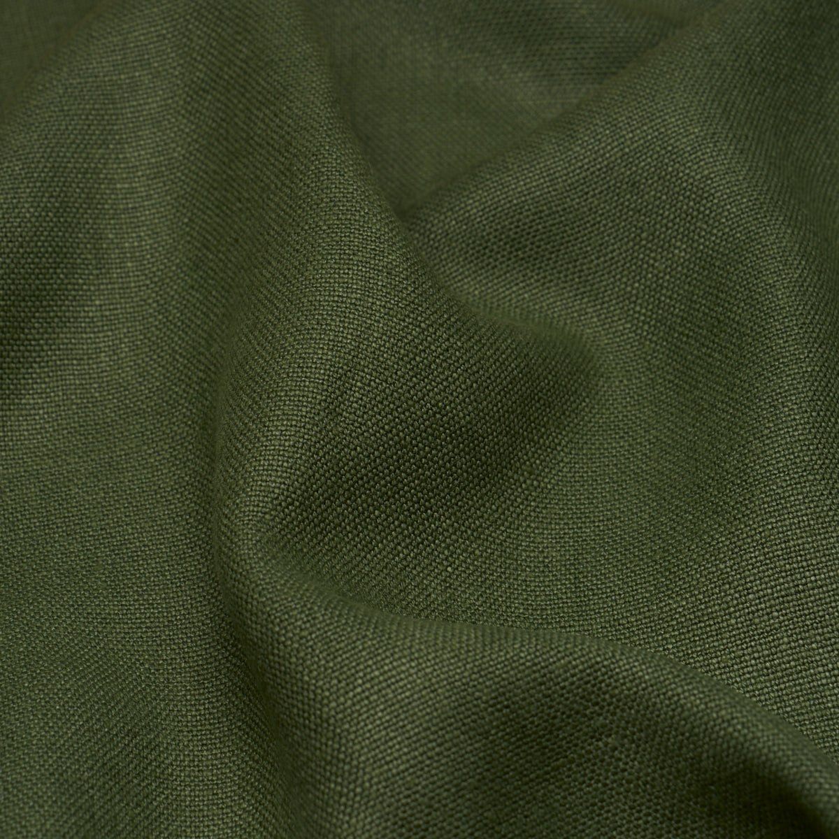 Hunter green linen fabric close-up with a textured surface and soft draped folds.