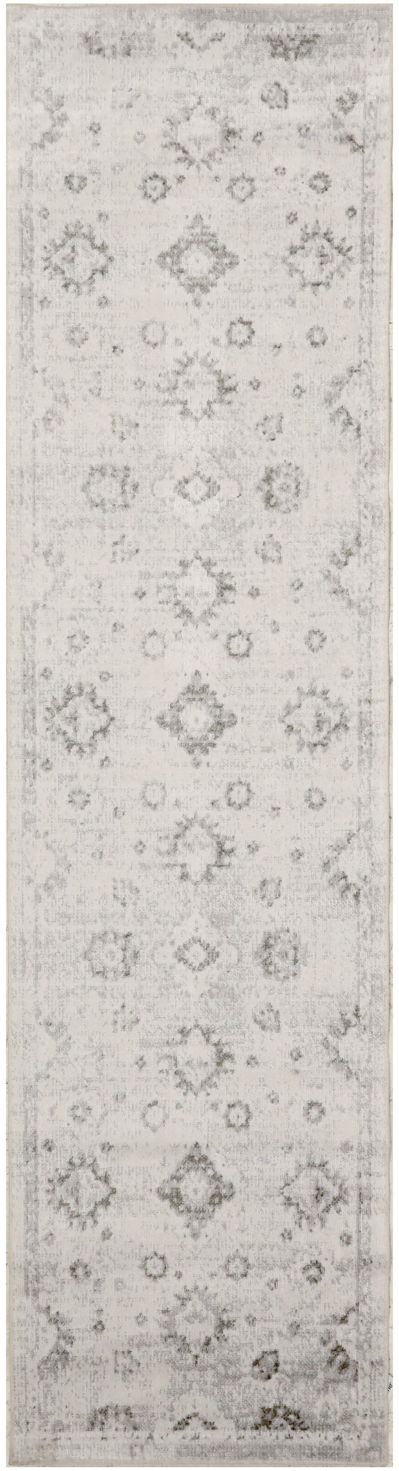 Long narrow vintage rug runner in light gray and ivory with distressed floral medallions and diamonds; subtle border.