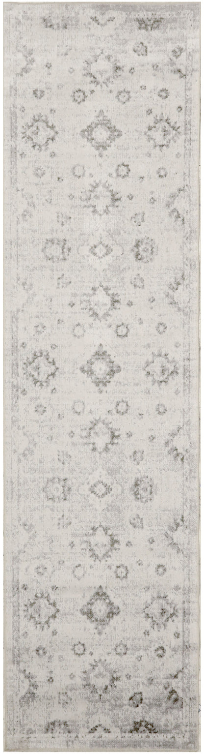 Long narrow vintage rug runner in light gray and ivory with distressed floral medallions and diamonds; subtle border.