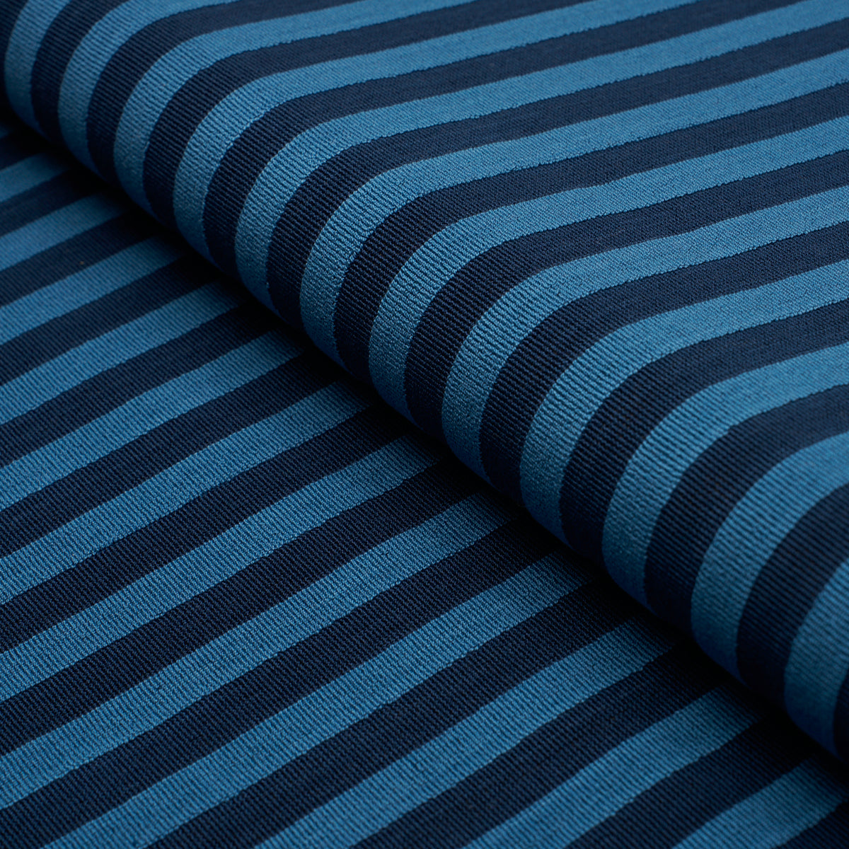 Blue woven fabric with a pipe illusion pattern.