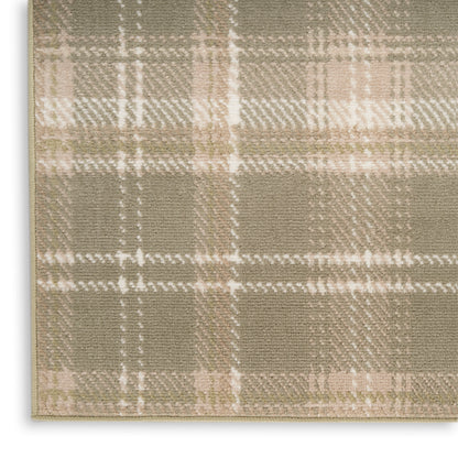 Beige plaid rug close-up with olive and cream tones, woven textile texture and stitched edge.