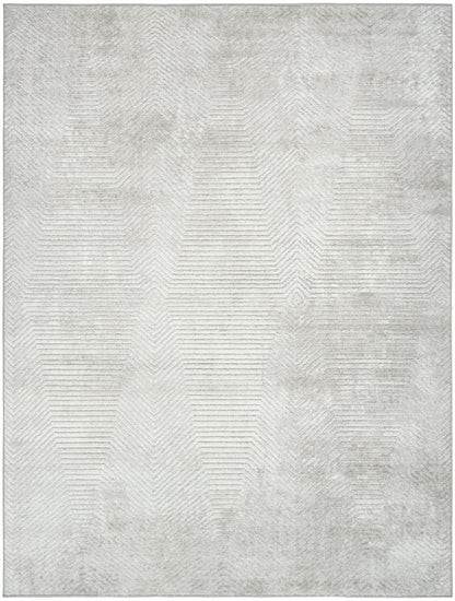 Rectangular light gray rug with subtle geometric chevron pattern and distressed texture for modern decor.