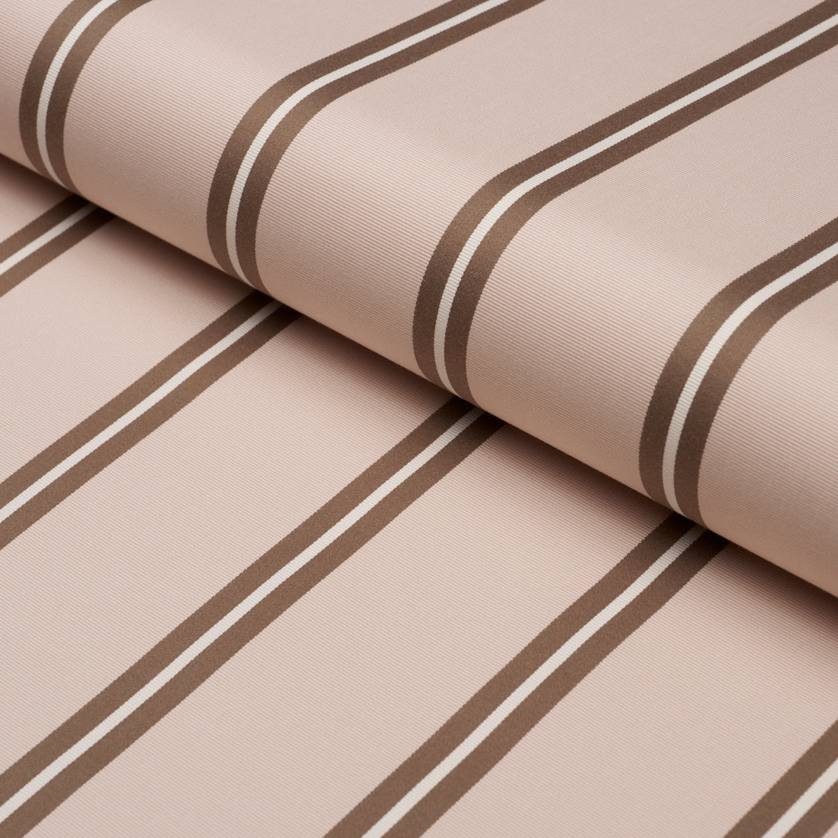 Blush-pink woven fabric with dark brown stripes, rolled textile for upholstery or drapery.