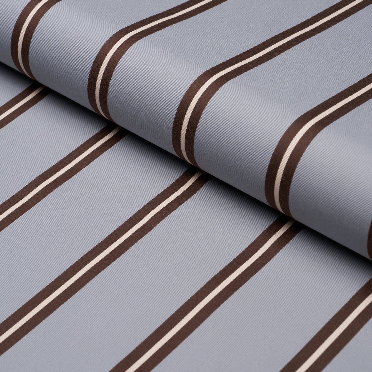 Sky blue striped woven fabric, rolled textile suitable for shirts or upholstery.