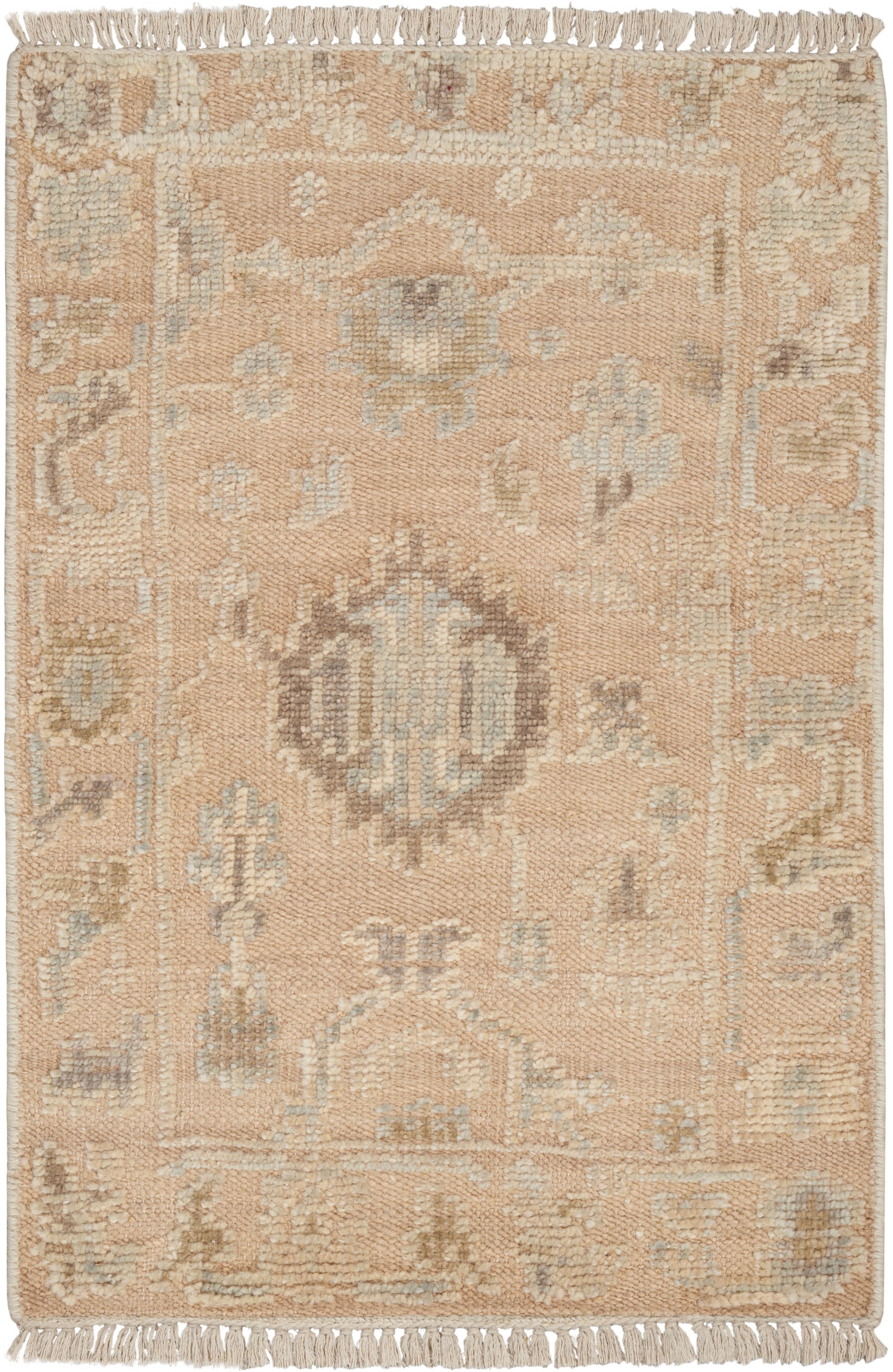 Beige/pale peach rug with light blue/ivory central medallion, geometric motifs & fringe on short ends.
