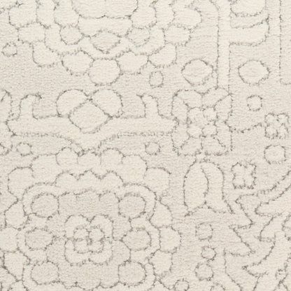 Cream textured rug with raised floral and geometric motifs in soft plush pile