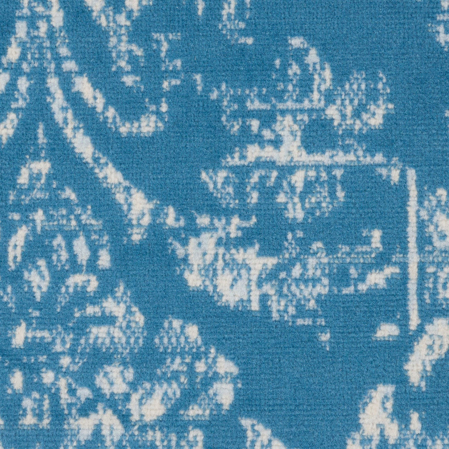 Blue woven rug with white damask floral pattern, round 5' diameter, vintage style.