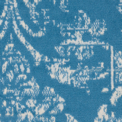 Blue woven rug with white damask floral pattern, round 5' diameter, vintage style.