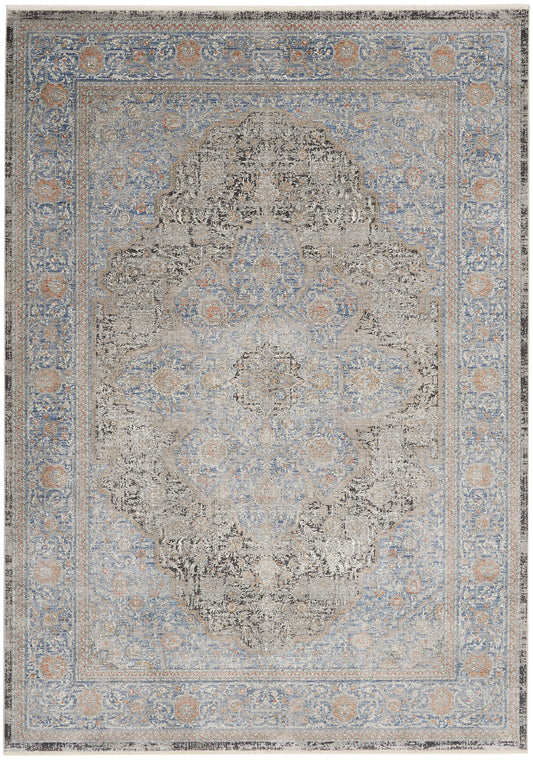 Rectangular distressed Persian-inspired rug in blue, beige and ivory with a central medallion and ornate floral border.
