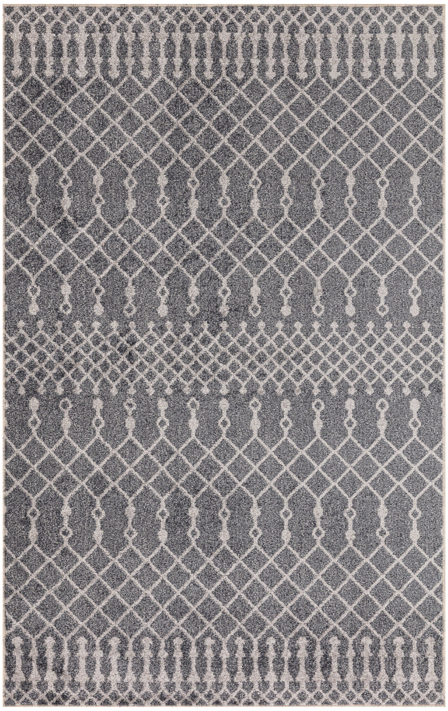 Grey area rug with white geometric lattice and teardrop motifs; contemporary, boho-style rug.