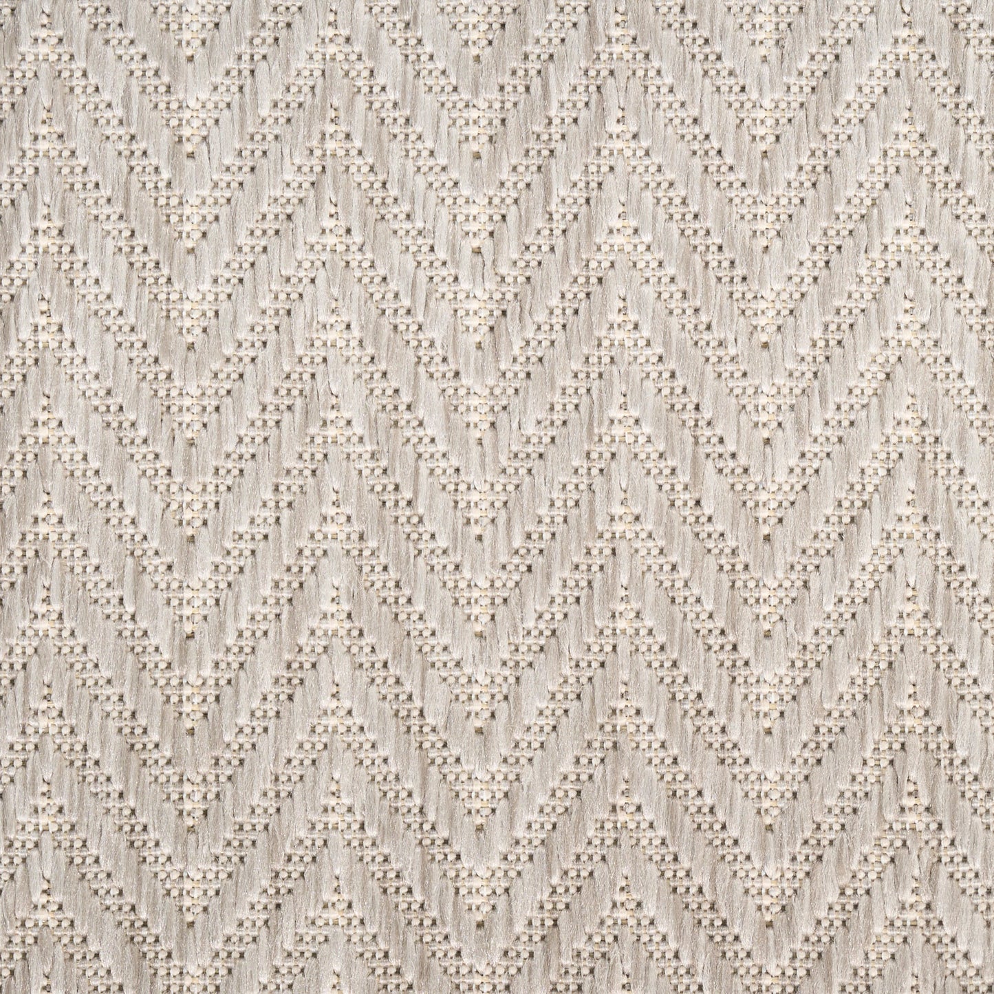 Beige textured knit fabric with chevron zigzag pattern and raised bobble details; cozy sweater or throw blanket material.