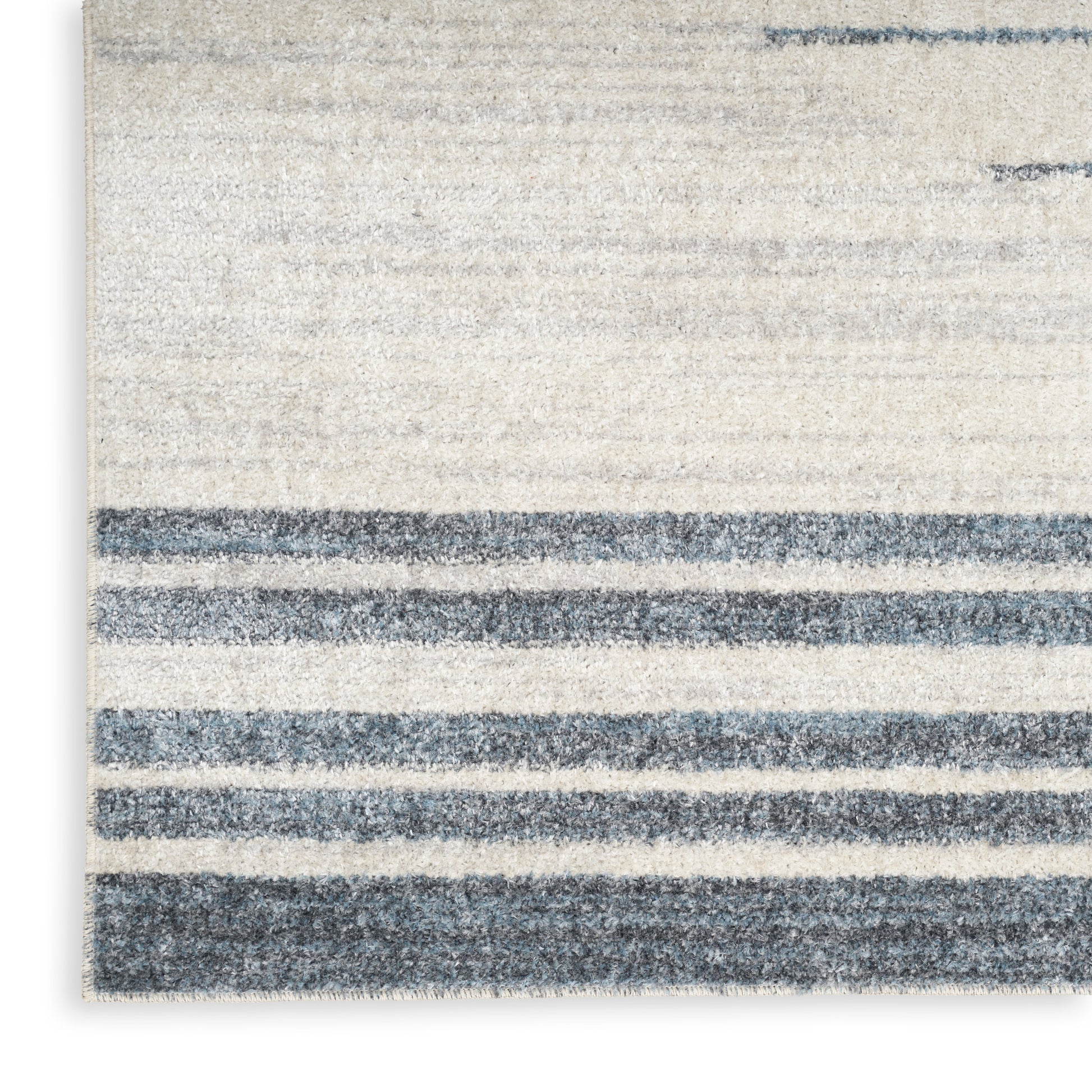 Beige rectangular rug with dark blue horizontal stripes and soft, textured pile.