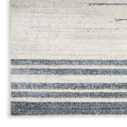 Beige rectangular rug with dark blue horizontal stripes and soft, textured pile.