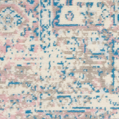 Pastel abstract patterned rug with cream base, pink, blue and taupe accents; distressed vintage look.