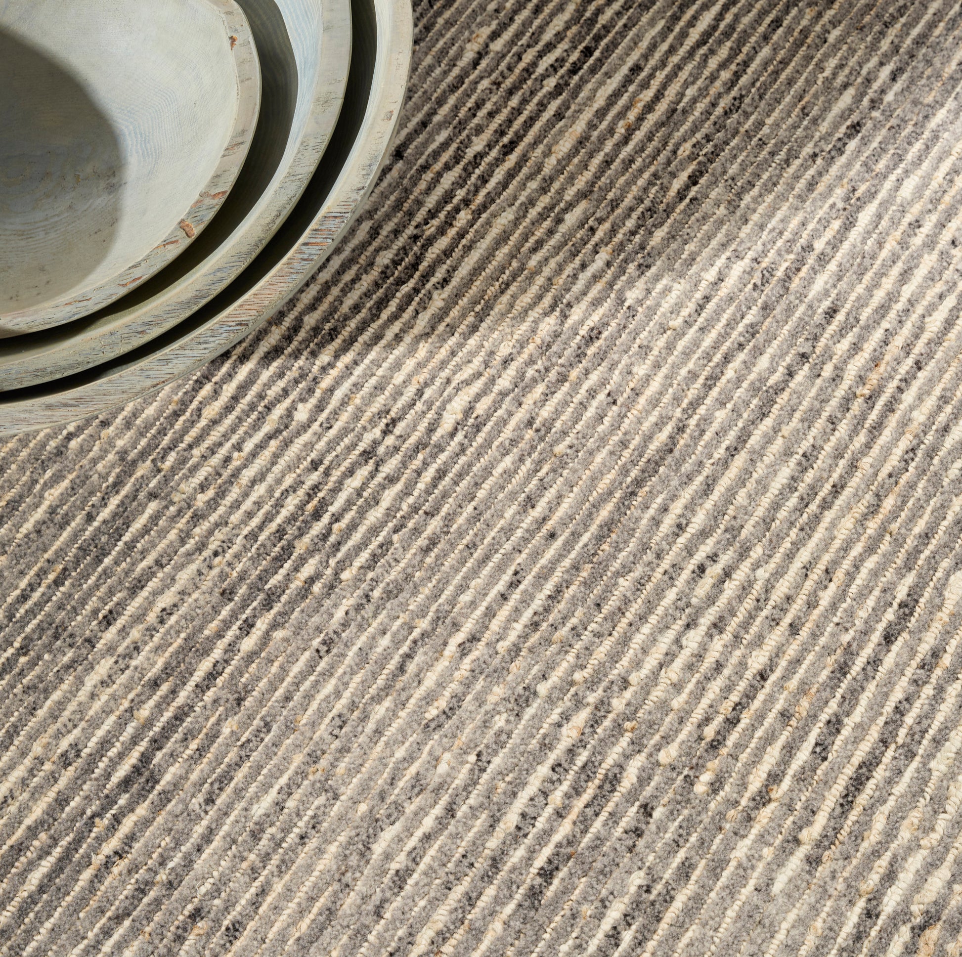 Pale green striped textured rug.