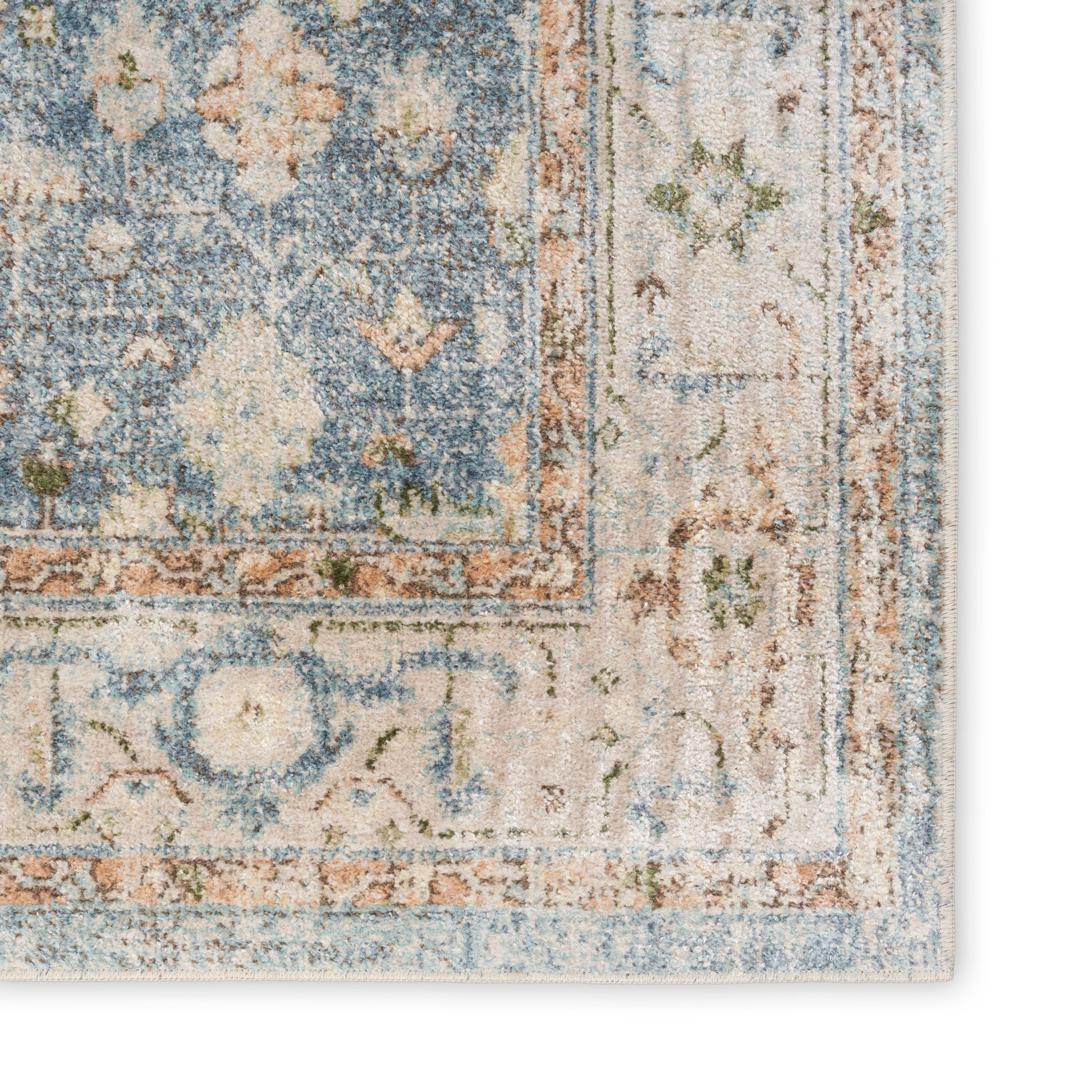 Blue and ivory oriental rug corner with floral motifs, orange border and distressed finish.