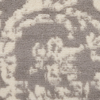 Gray and ivory abstract patterned area rug with plush, textured surface.