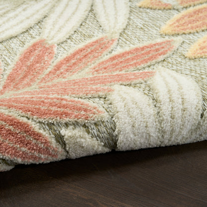 Soft tufted modern area rug with cream, peach and pink leaf pattern, plush pile, rolled edge, on dark wood floor