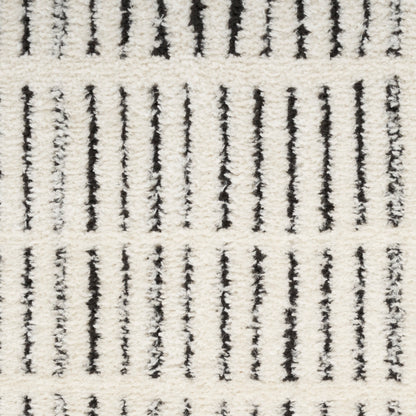 Cream rug with vertical black lines and plush, textured pile in a Scandinavian style.