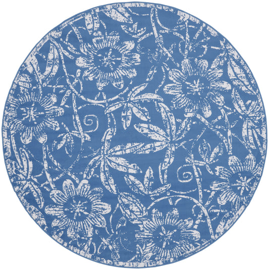 Round blue rug with white floral damask pattern and vine motifs; decorative home accessory.