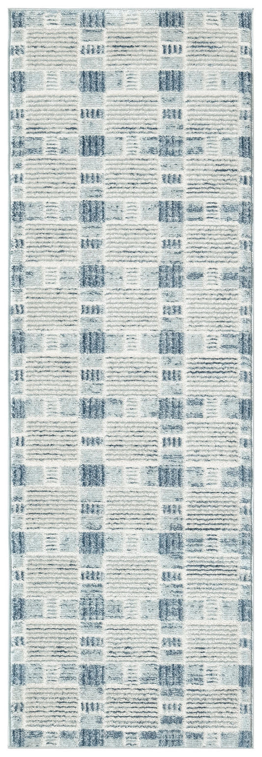 Long blue and ivory geometric patchwork runner rug with distressed lines and soft plush pile.