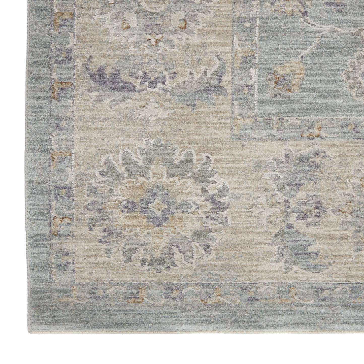 Soft blue-beige oriental rug with lavender floral medallions and a bordered edge.