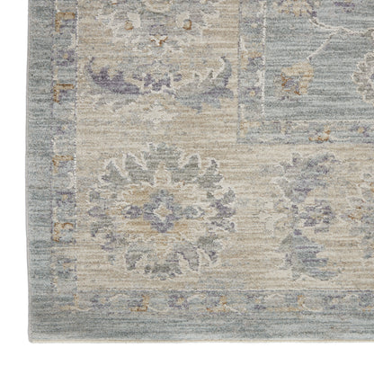 Soft blue-beige oriental rug with lavender floral medallions and a bordered edge.