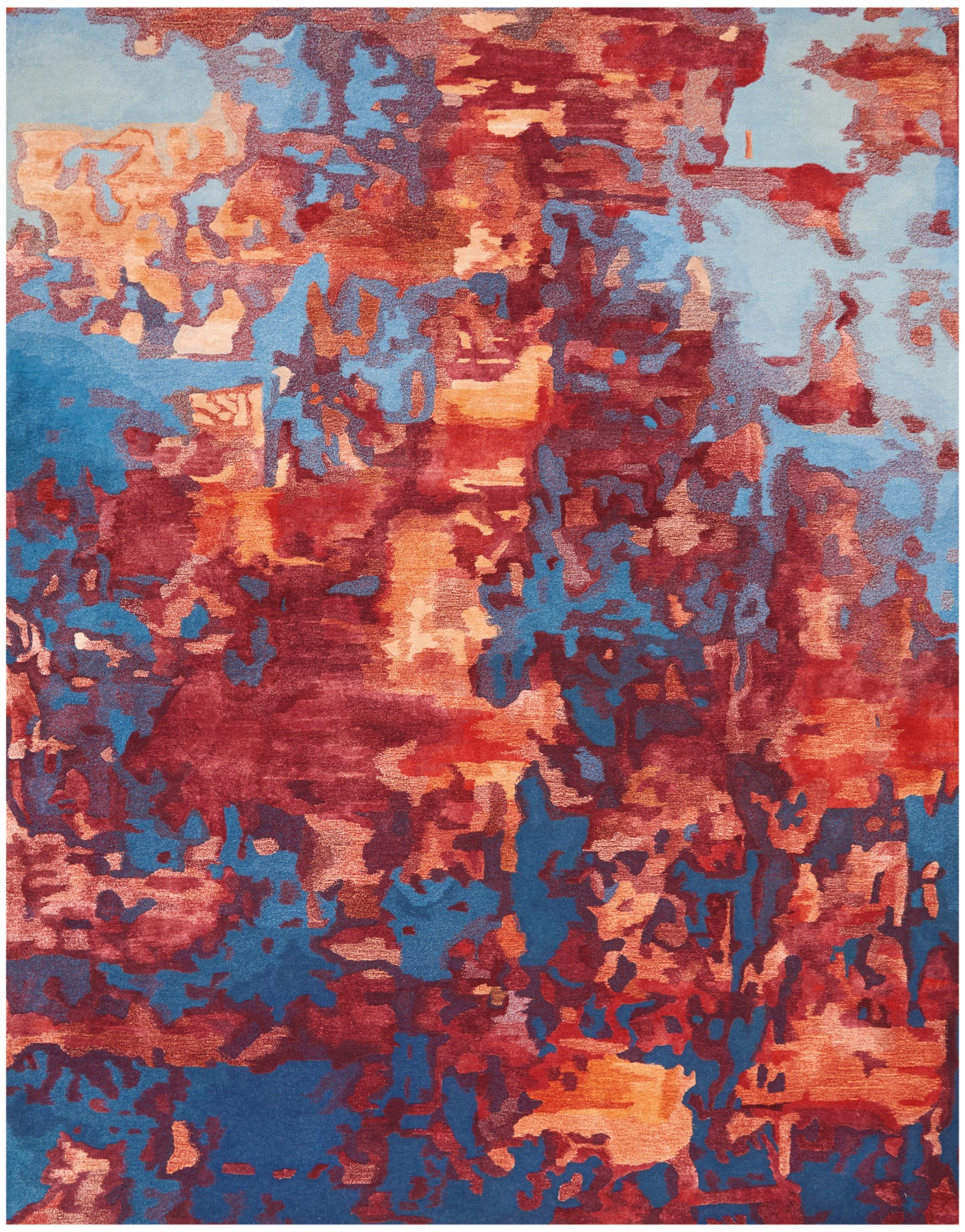 Rectangular abstract area rug with bold reds, blues, and orange hues in irregular blocks; contemporary, cozy statement piece.
