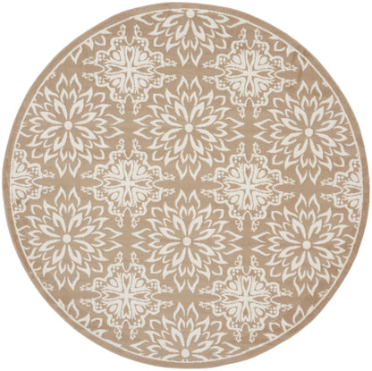 Round beige rug with white intricate mandala floral motif; boho chic, versatile for living spaces.