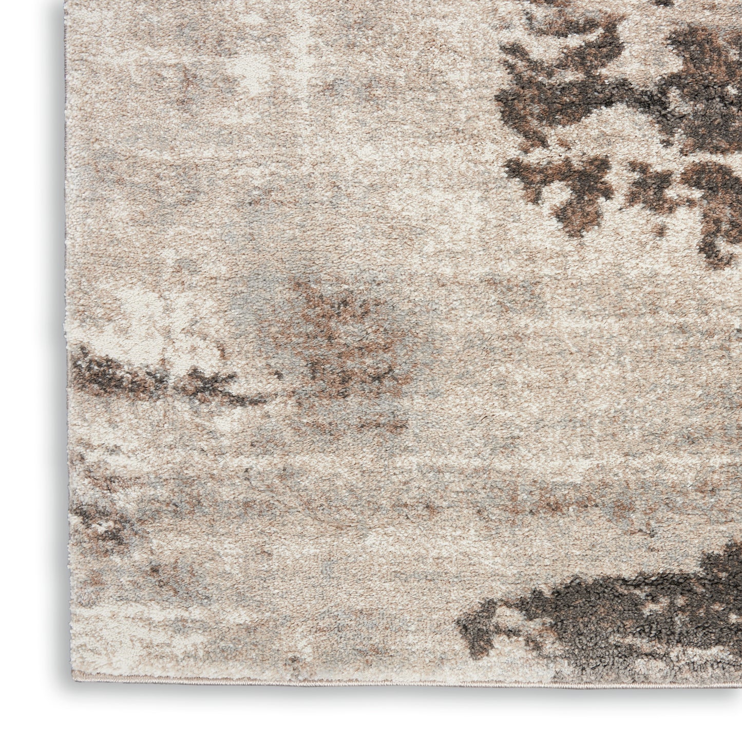 Beige distressed area rug with taupe and gray abstract pattern and soft, textured finish.