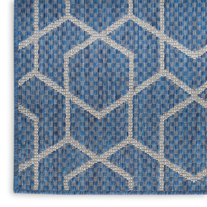 Blue woven rug with white geometric diamond trellis pattern; textured textile for living room.