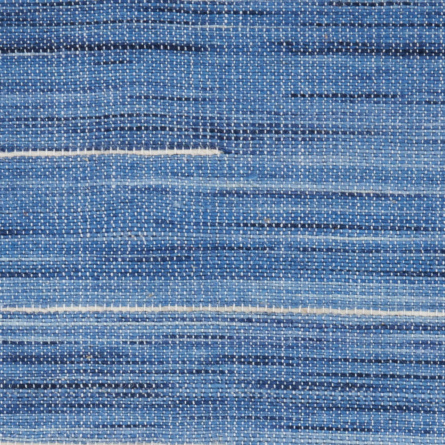 Blue woven rug with white horizontal stripes; denim-like, casual texture.