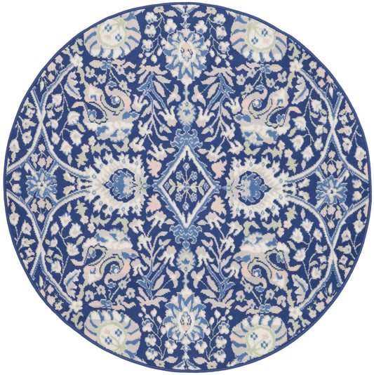 Round navy rug with intricate white floral damask pattern.