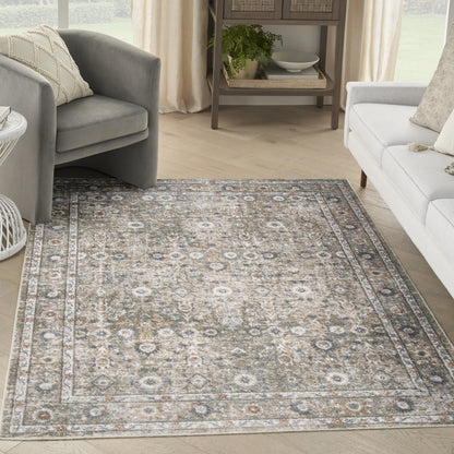 Rectangular distressed oriental rug with beige, gray and ivory tones, floral medallion border; low-pile for a light living room.