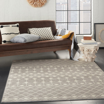 Bohemian 7' x 10' rug in a bright loft with city views; beige lattice pattern on the floor.