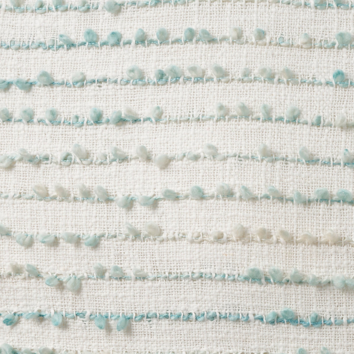 Cream woven fabric featuring horizontal rows of mint-green pom-pom fringe.