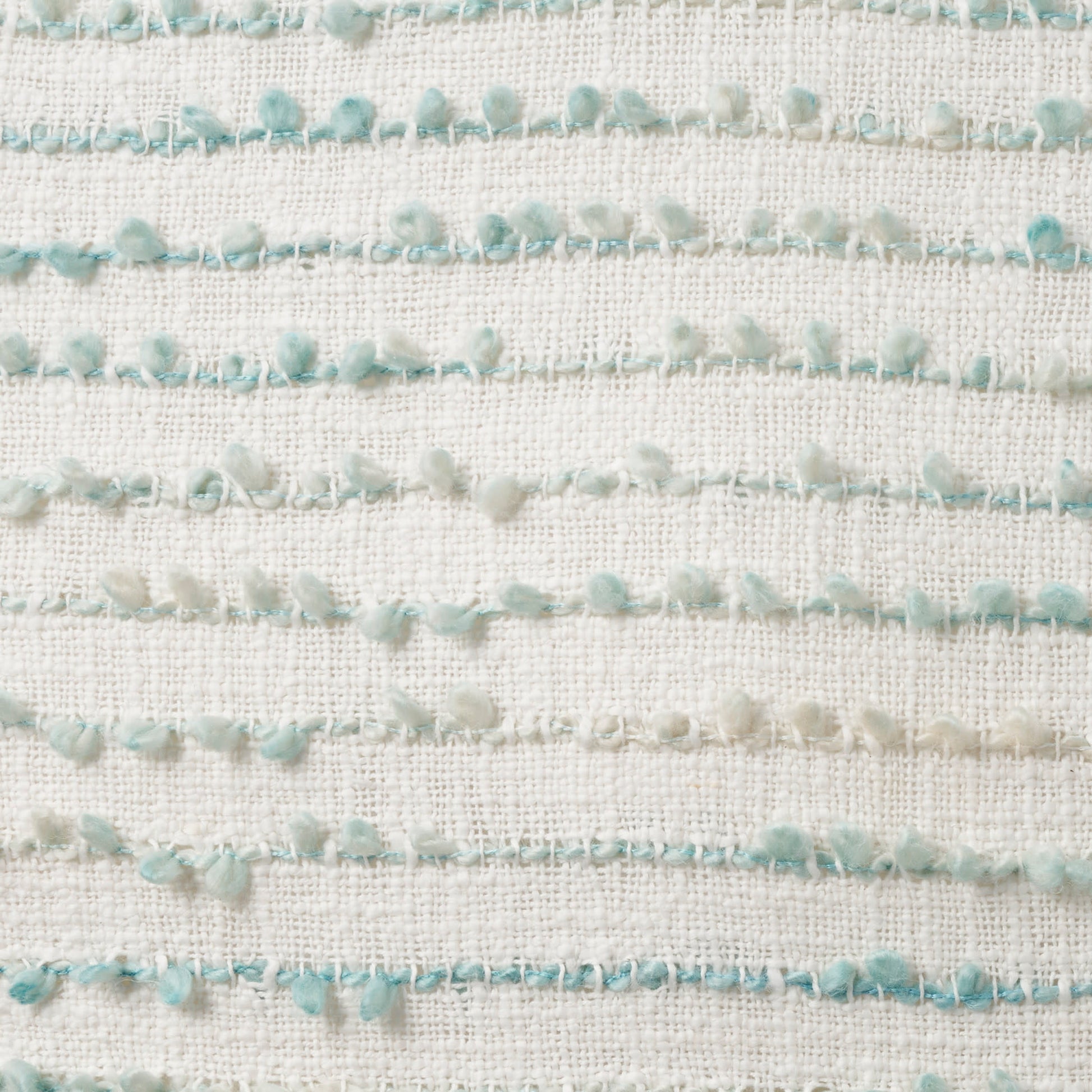 Cream woven fabric featuring horizontal rows of mint-green pom-pom fringe.