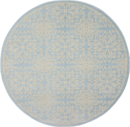 Round rug in pale blue with cream damask floral pattern; soft decorative accent for living room.